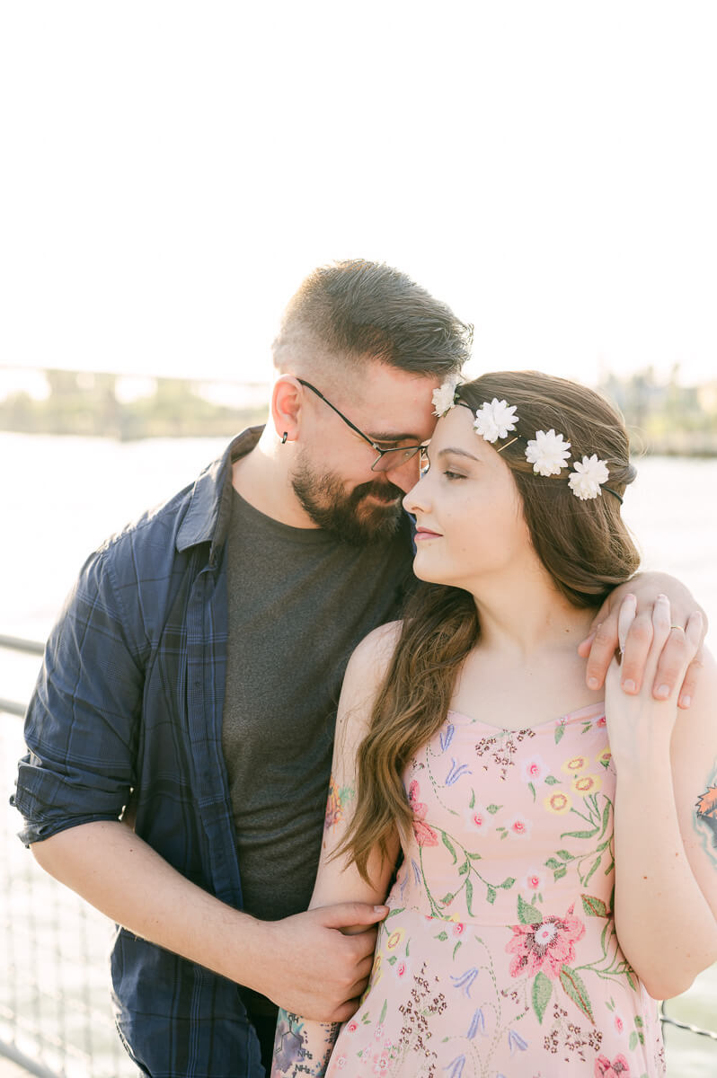 a couple with the kemah boardwalk in the background