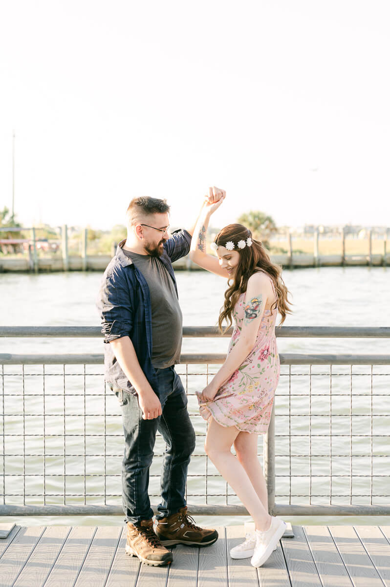 a couple with the kemah boardwalk in the background