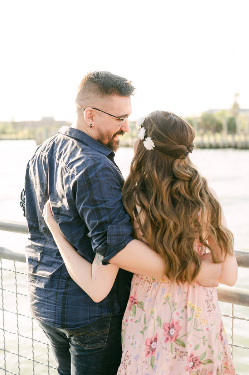 a couple with the kemah boardwalk in the background