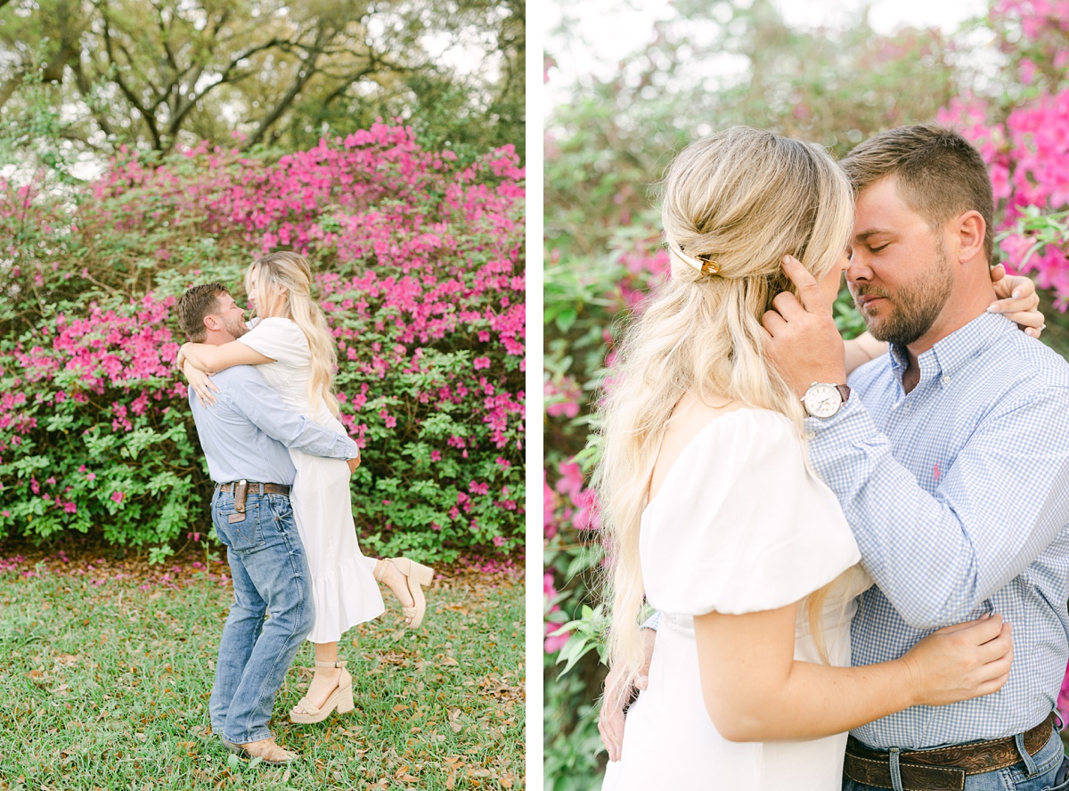 a couple spinning in front of pink flowers at their engagement session