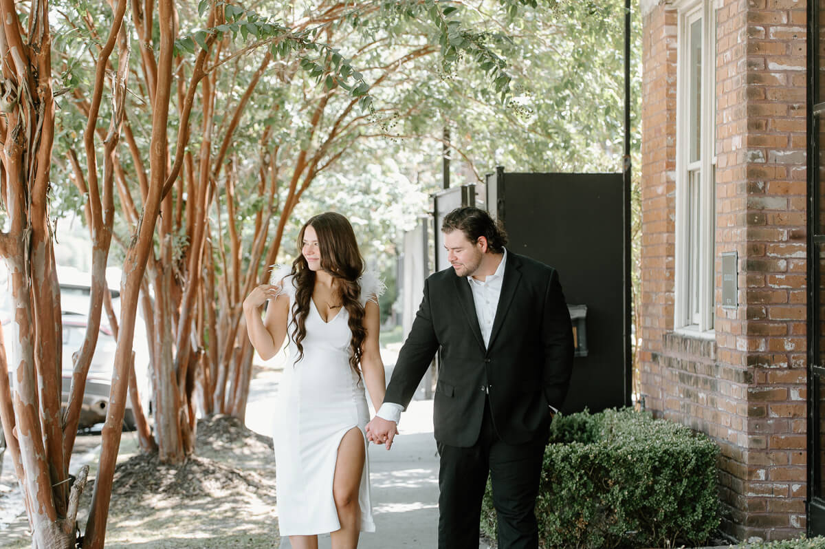 a couple walking outside of station 3 wedding venue