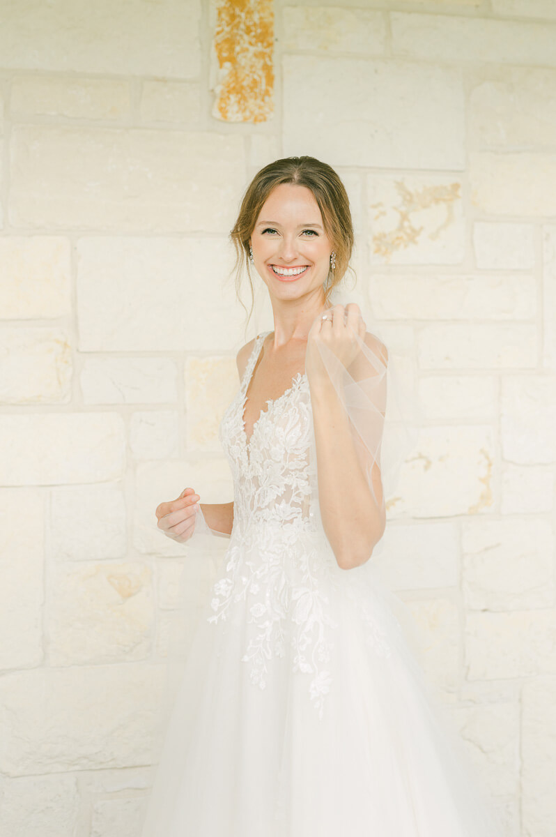 a bride holding her veil at briscoe manor wedding venue