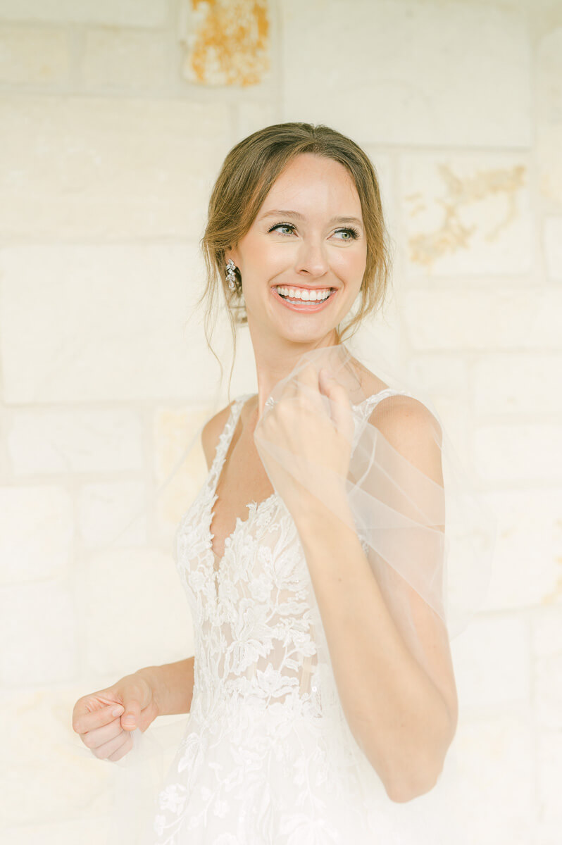 a bride holding her veil at briscoe manor wedding venue