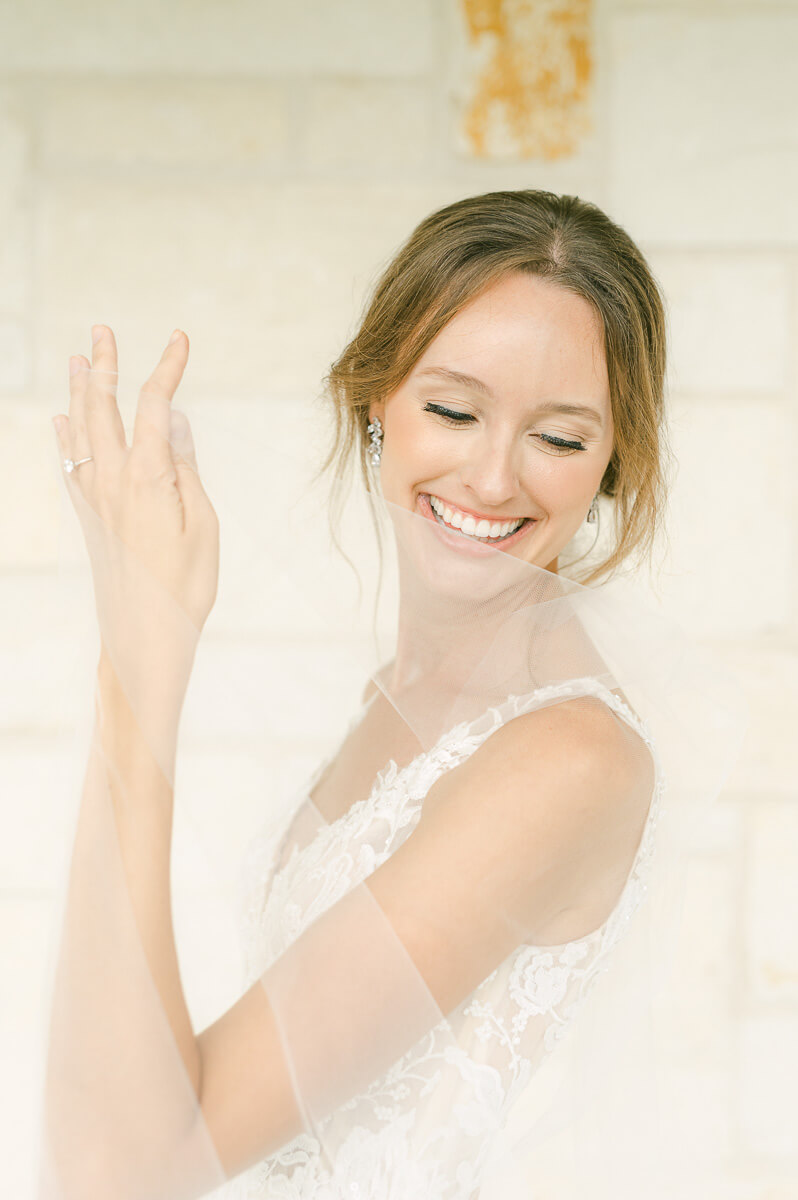 a bride holding her veil at briscoe manor wedding venue