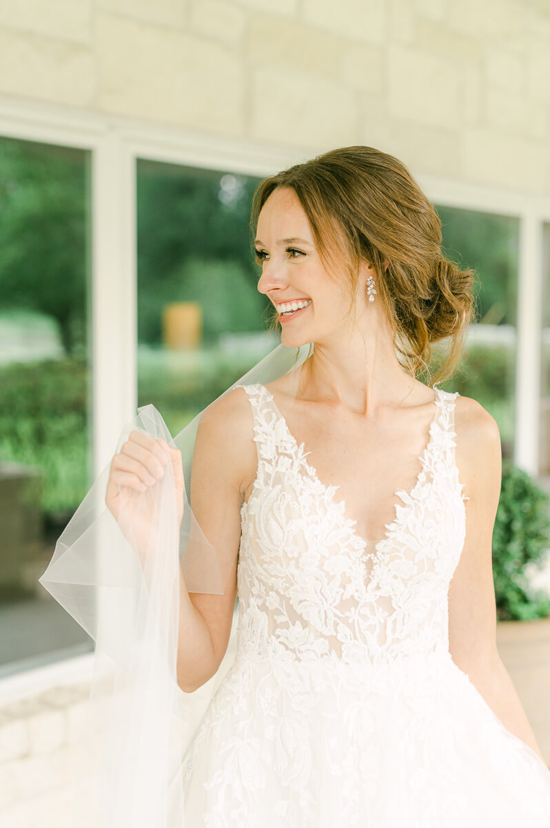 a bride holding her veil at a Richmond texas wedding venue