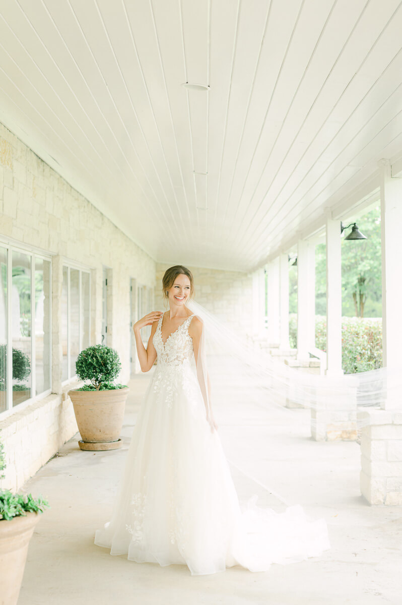 a bride laughing at her briscoe manor bridal session