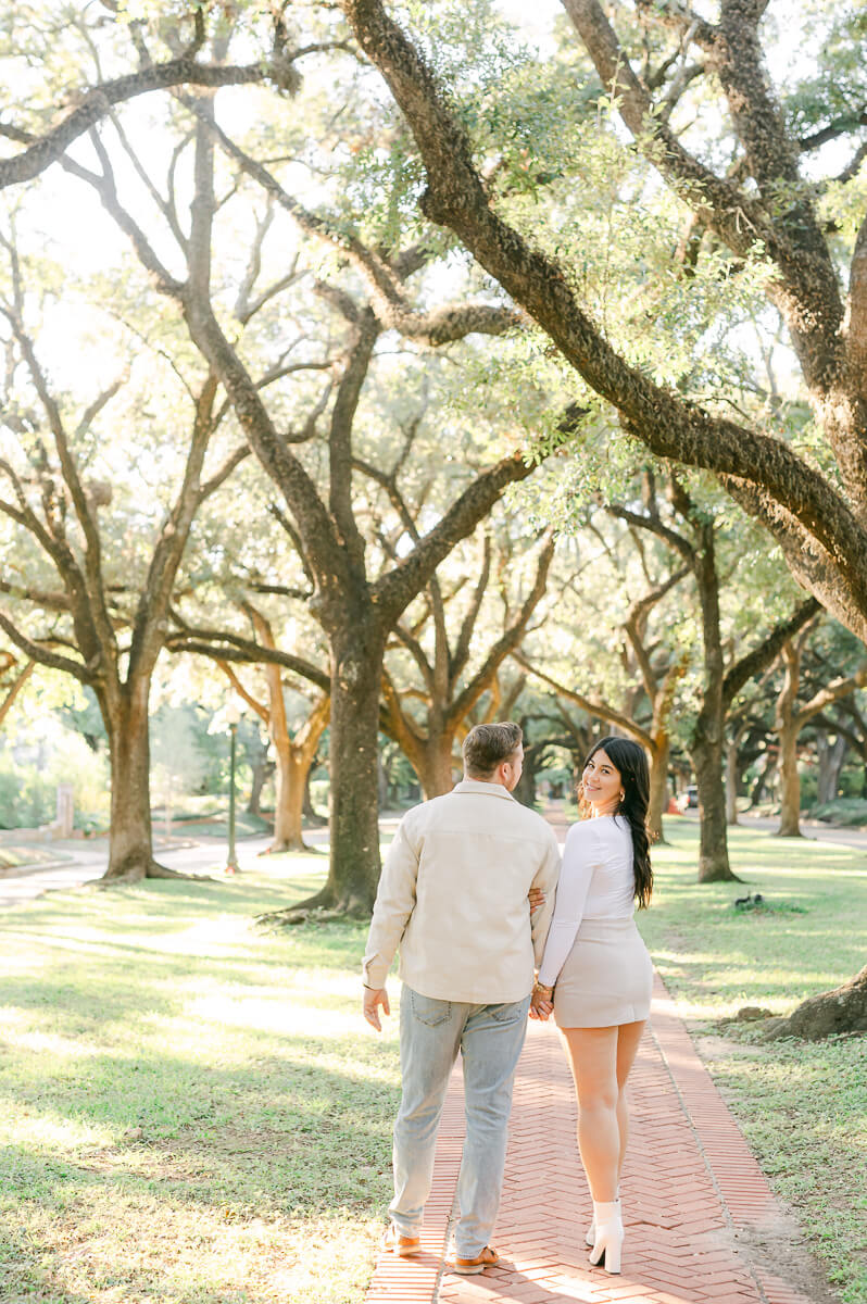 a couple walking along the path of north boulevard in houston