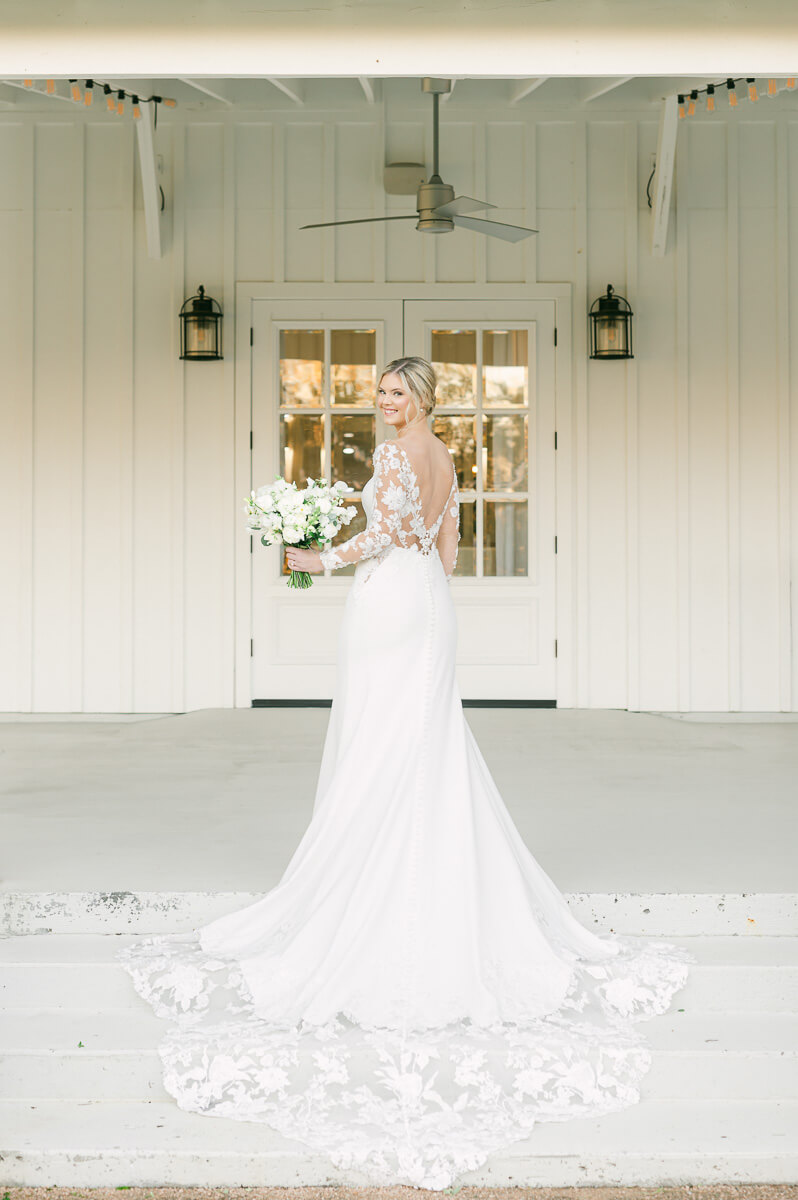 bride looking over her shoulder at the farmhouse bridal photography 