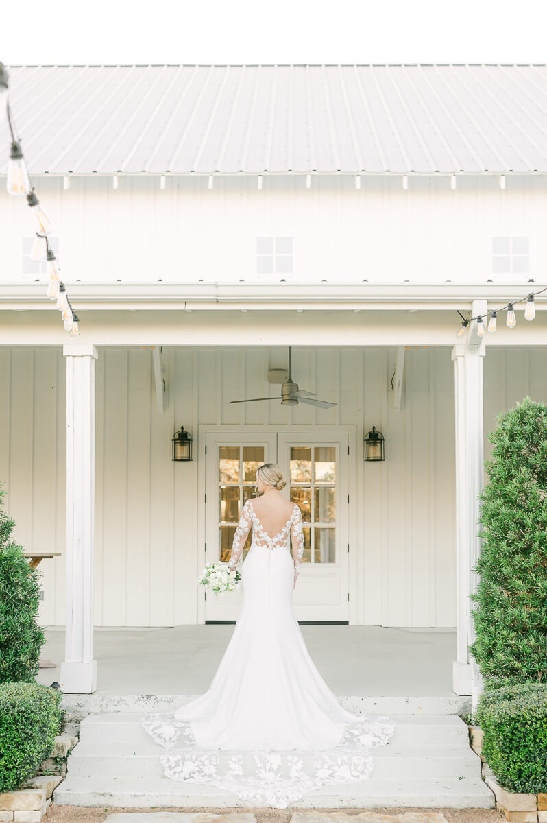 a bride with lace sleeves at the farmhouse bridal photography