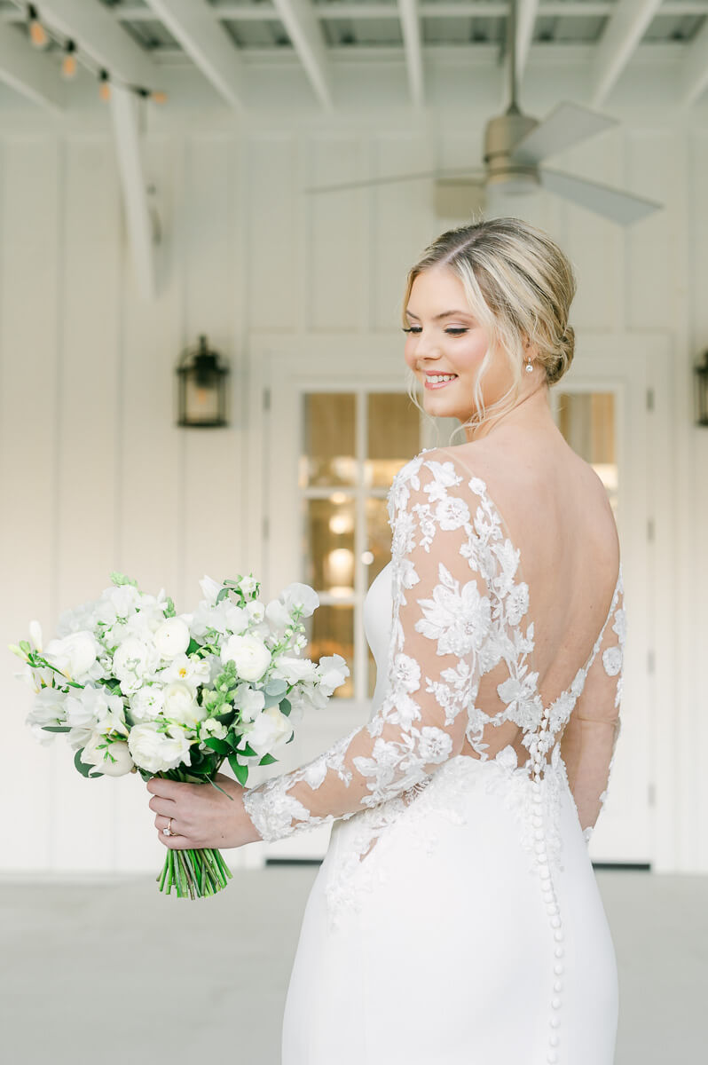 a bride with lace sleeves at the farmhouse bridal photography