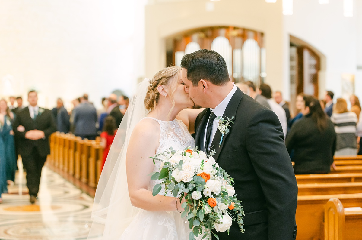 couple kissing at the end of the recessional 