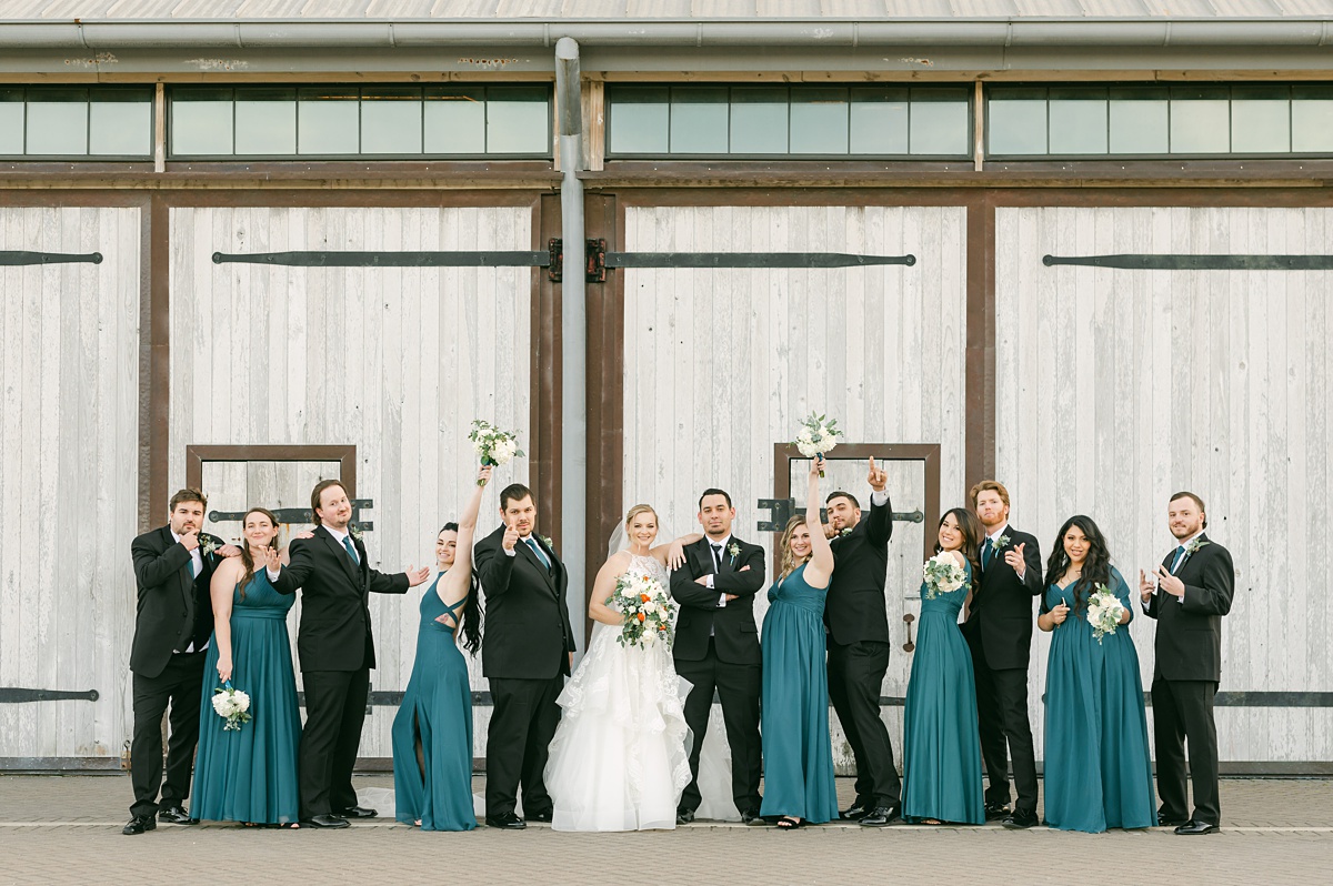 wedding party in front of the barn doors at beckendorff farms 