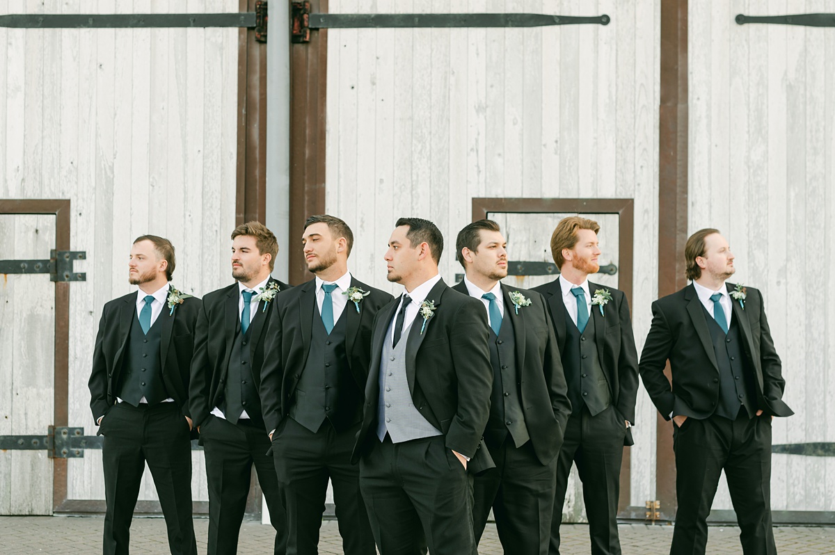 groomsmen taking pictures at beckendorff farms 