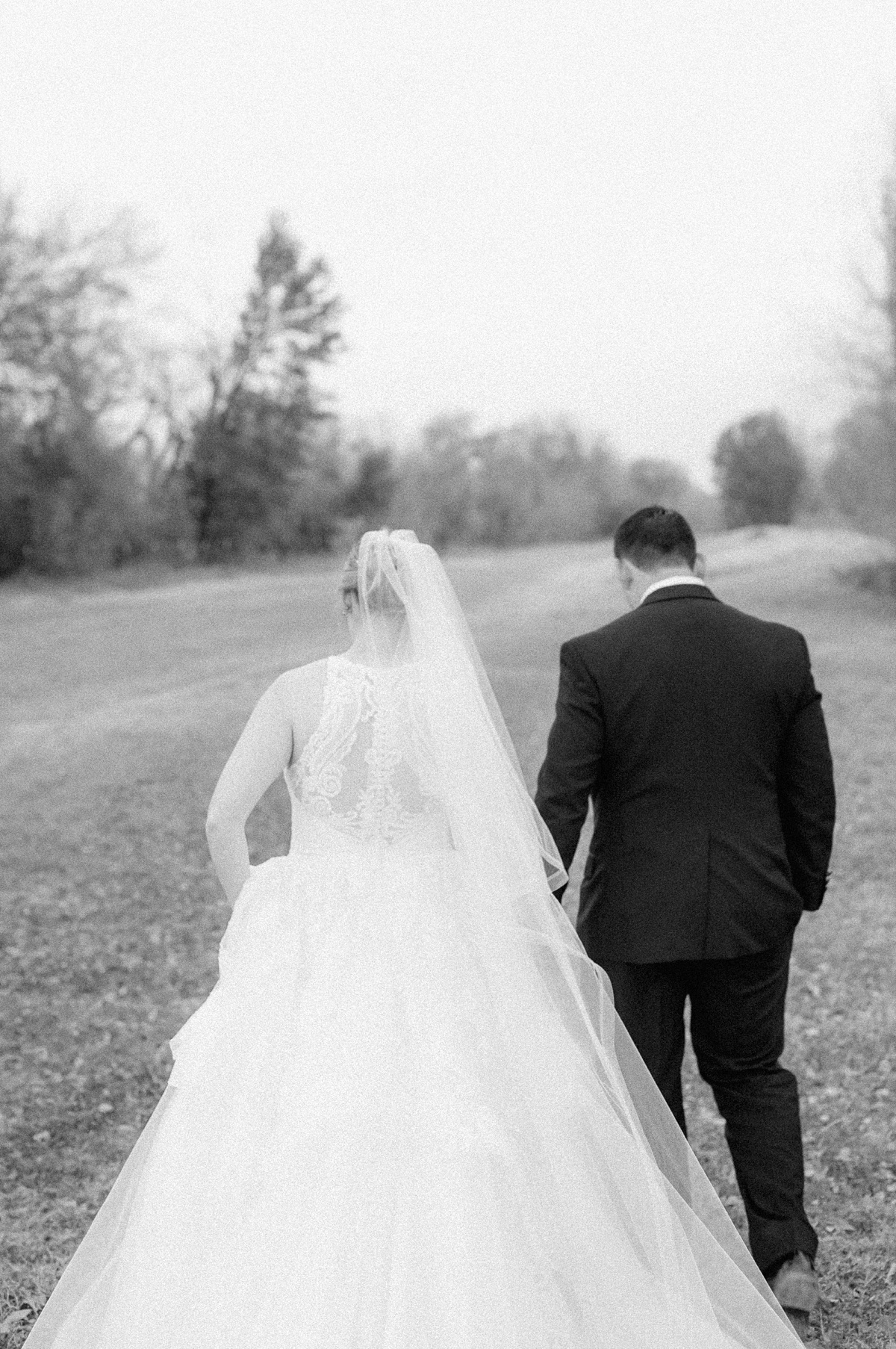 bride and groom walking to beckendorff farms 