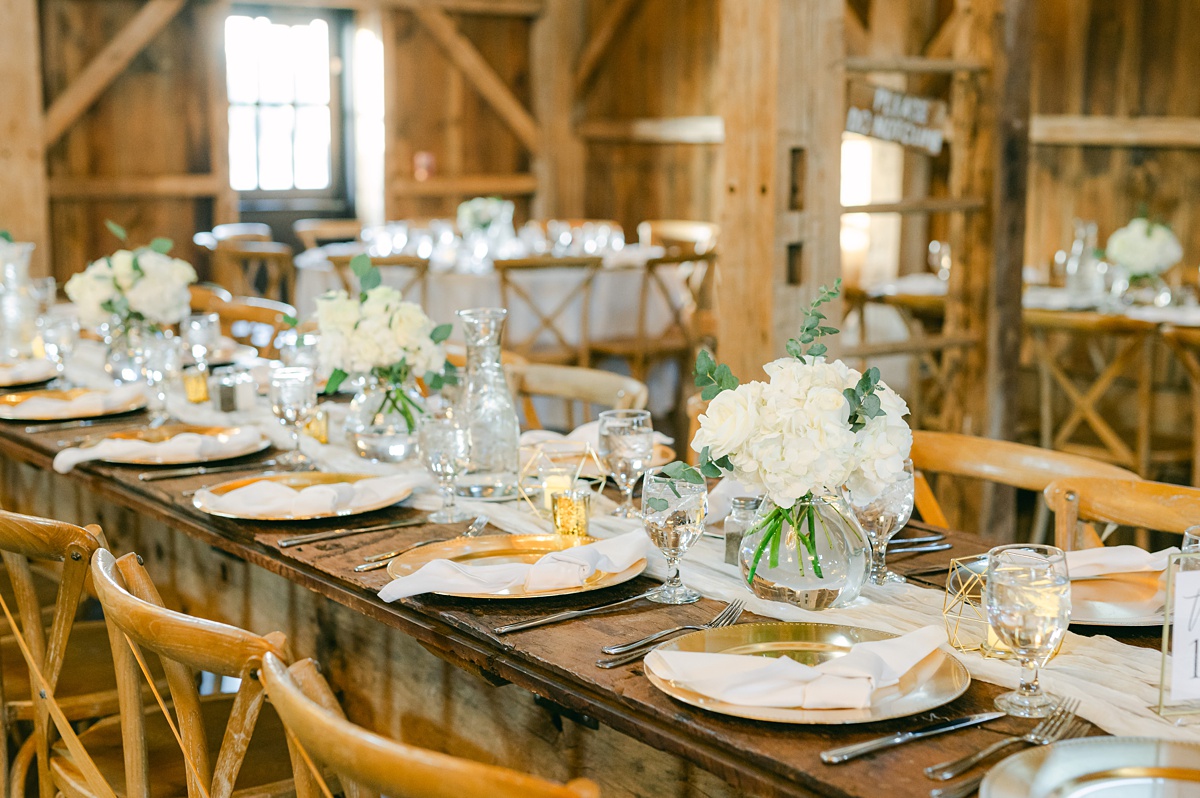 white florals and cream table settings for beckendorff farms reception 