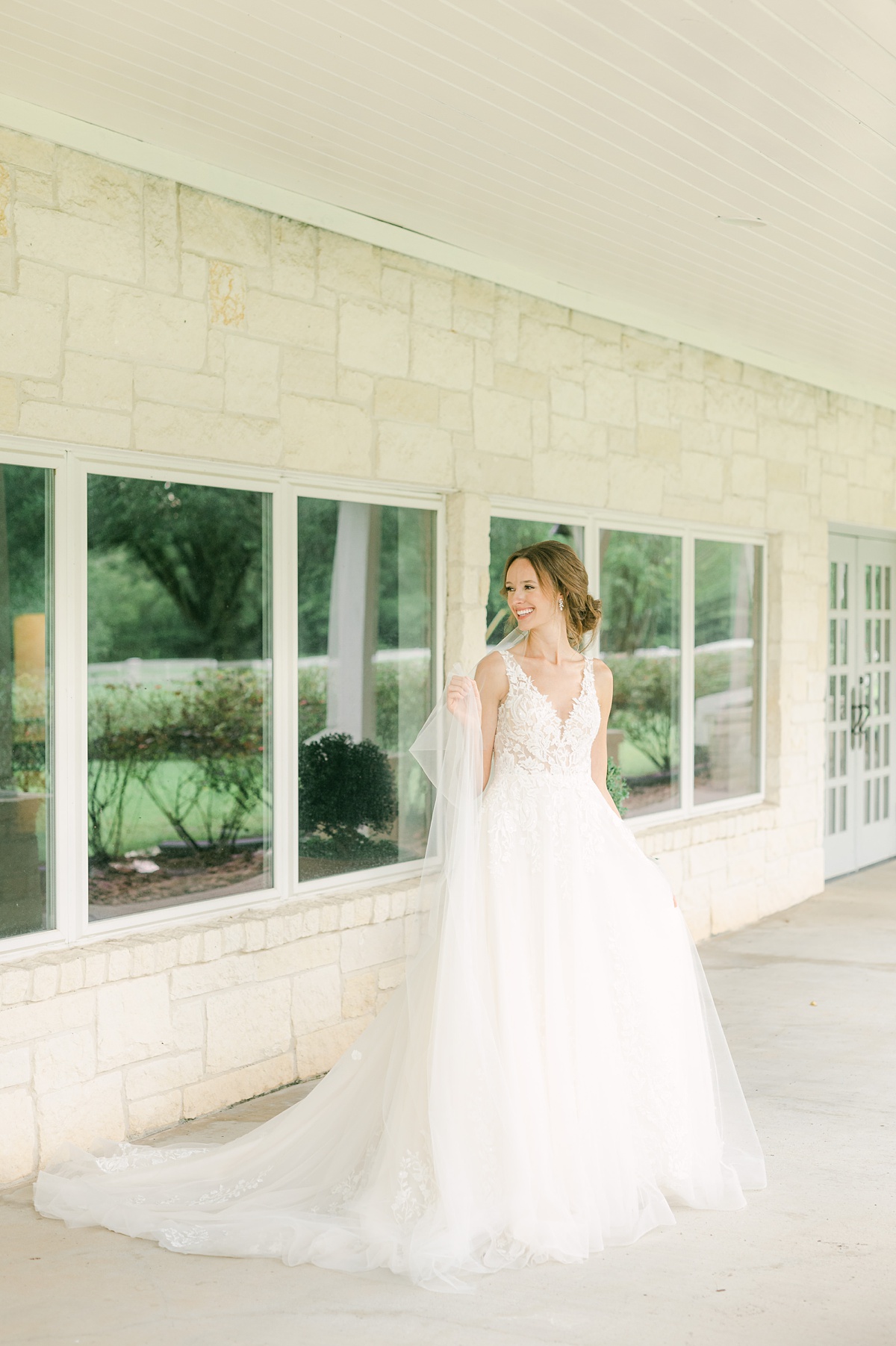 a bride holding her veil at a Richmond texas wedding venue