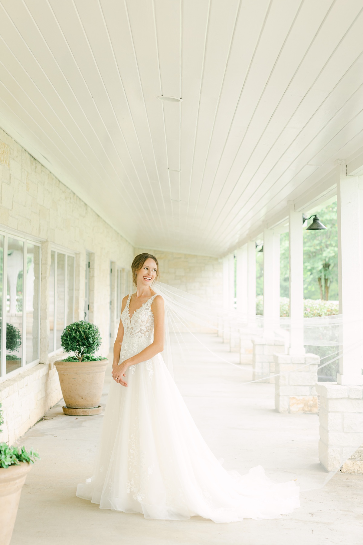 a bride laughing at her briscoe manor bridal session