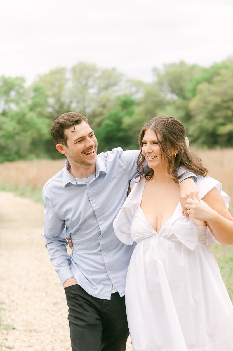 couple walking and laughing at their houston engagement photography session