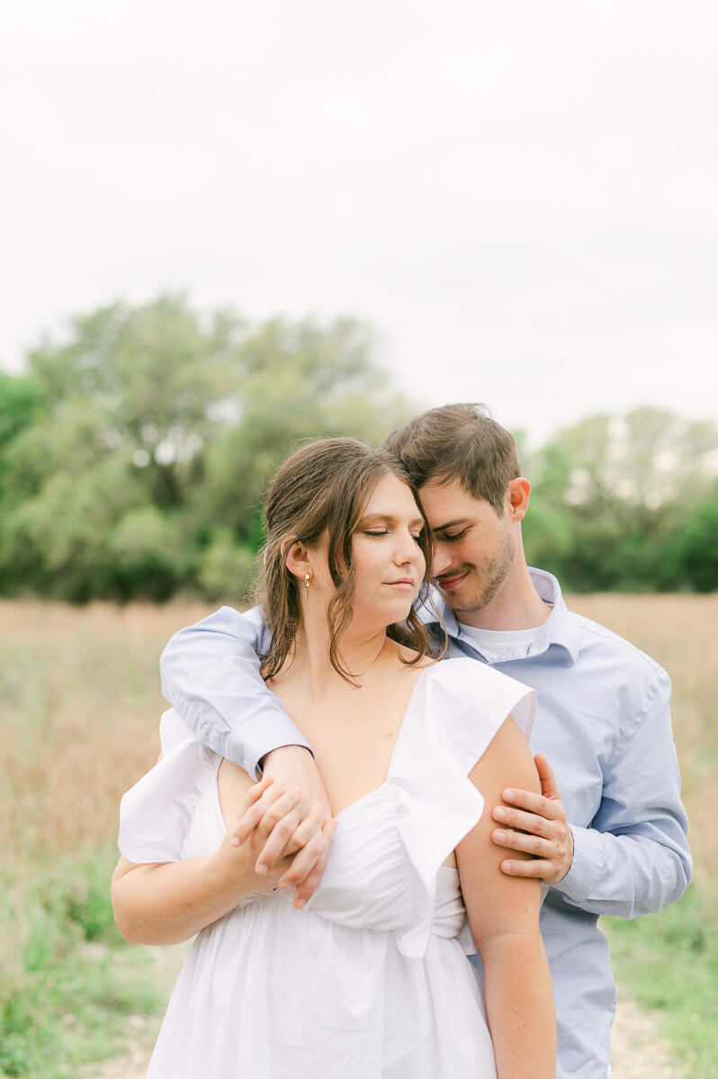 couple cuddling at brazos bend state park