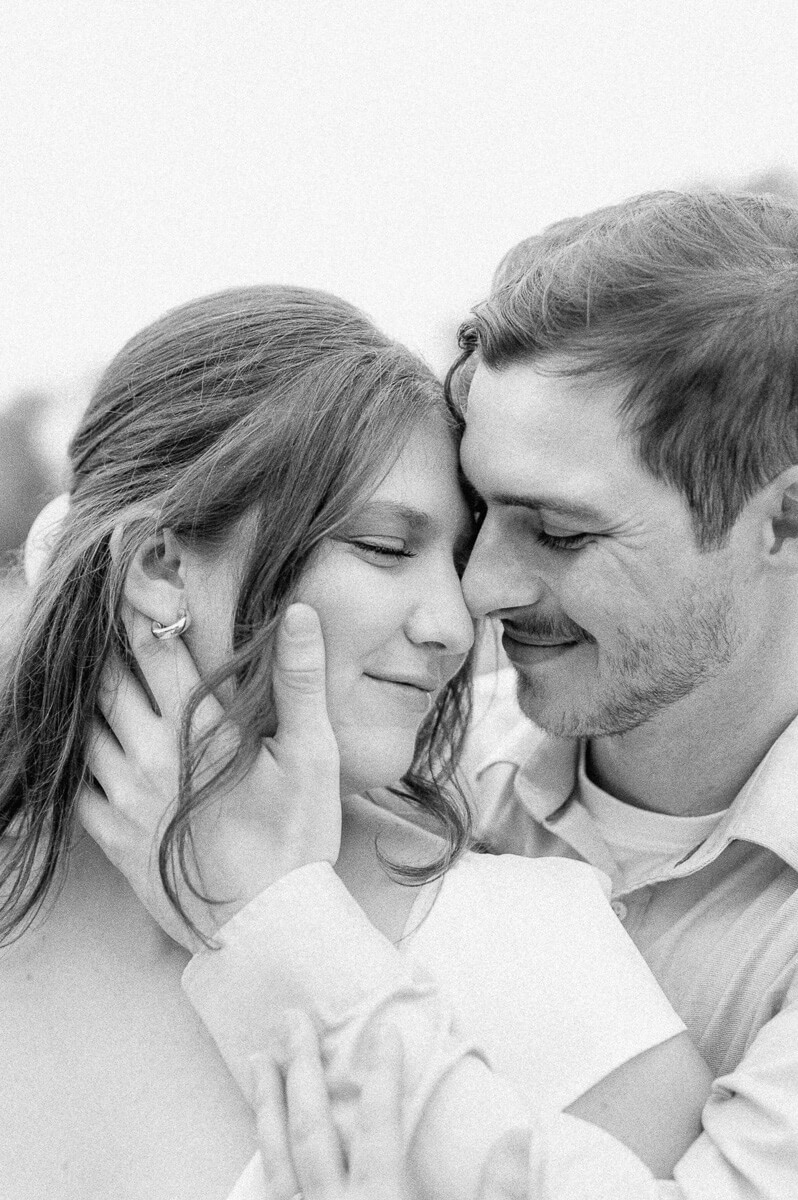 a cute couple cuddling in black and white