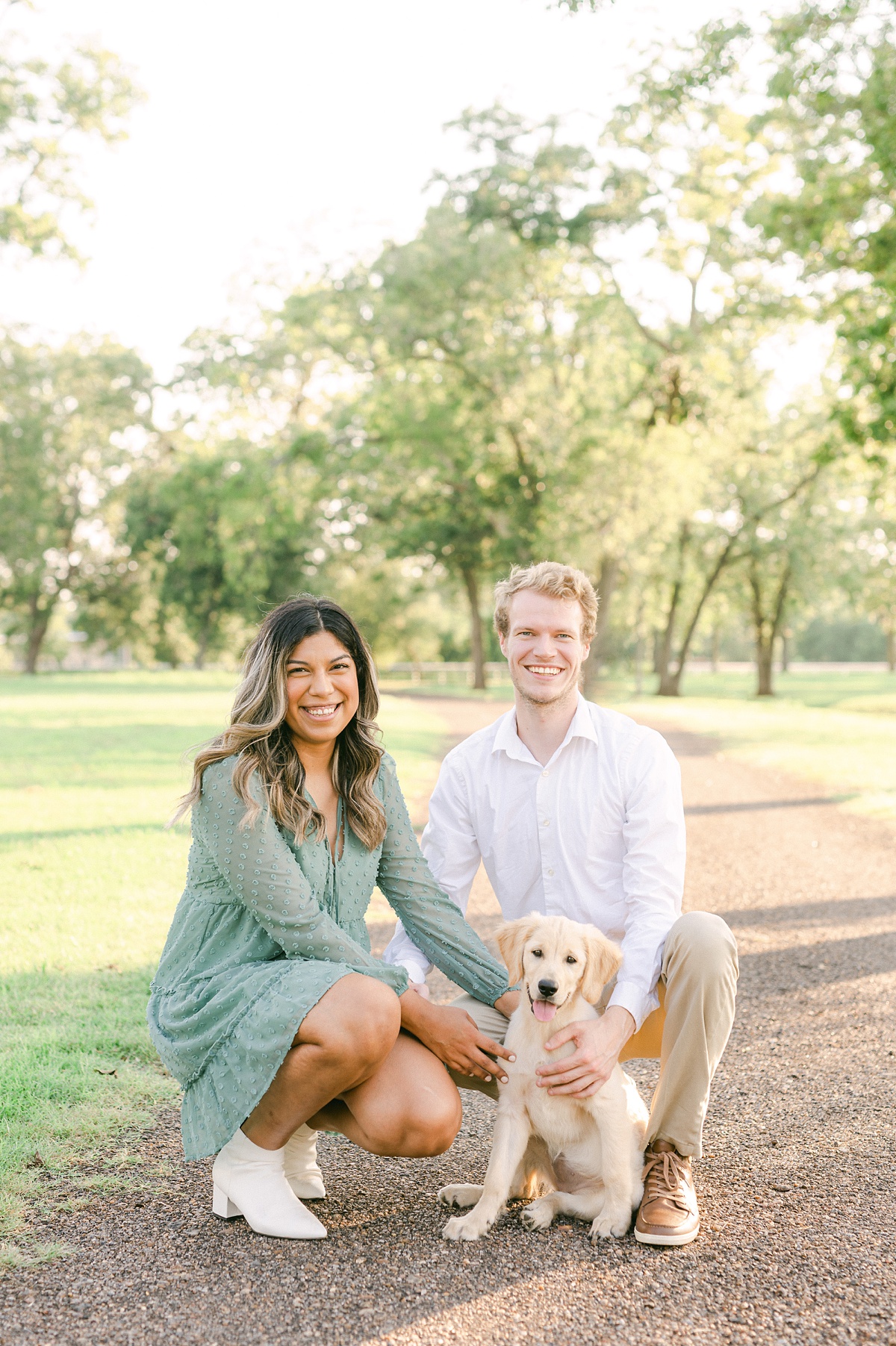 couple with their puppy at their engagement session with houston wedding photographer