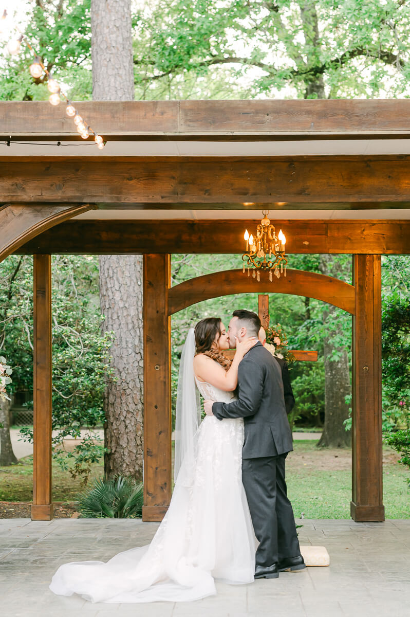 couple's first kiss during garden ceremony in Houston