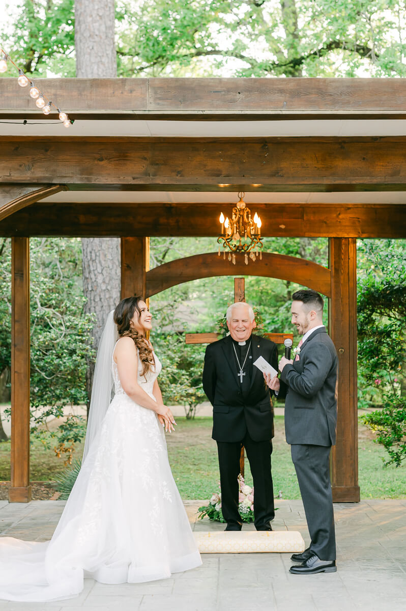 couple reading vows during garden ceremony