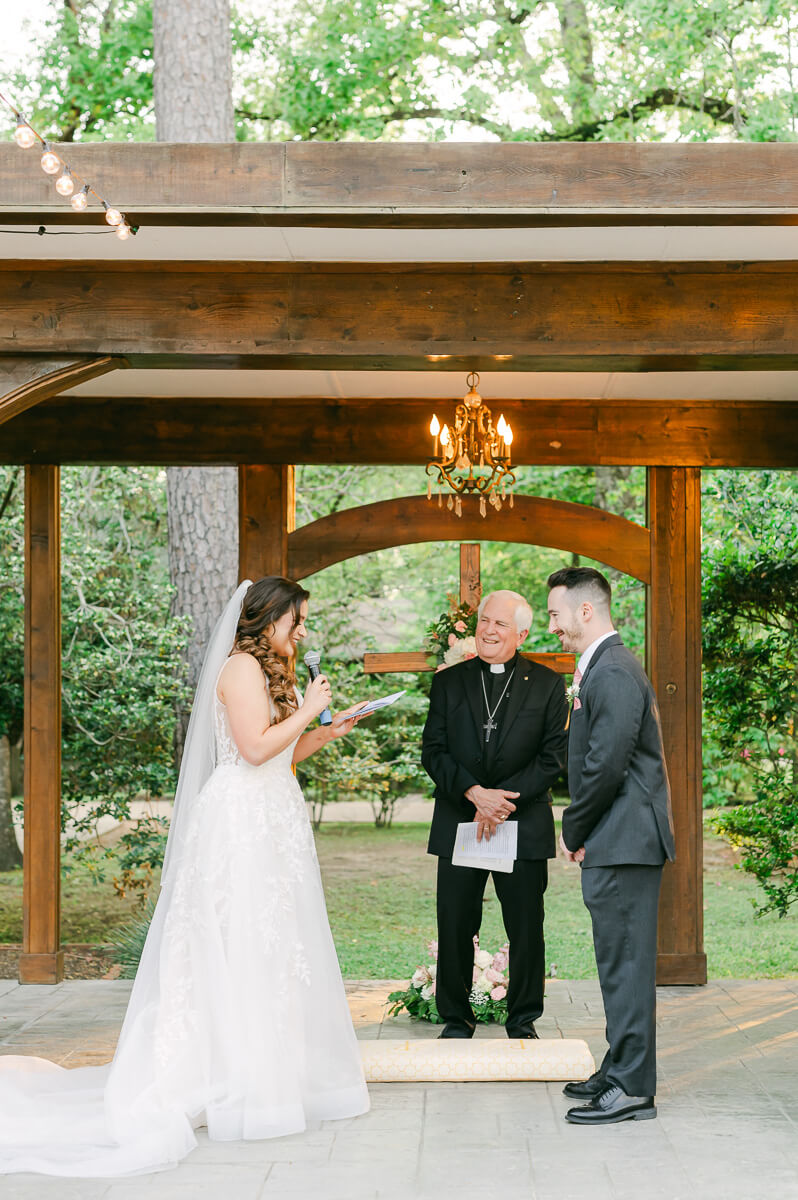 couple reading vows during garden ceremony