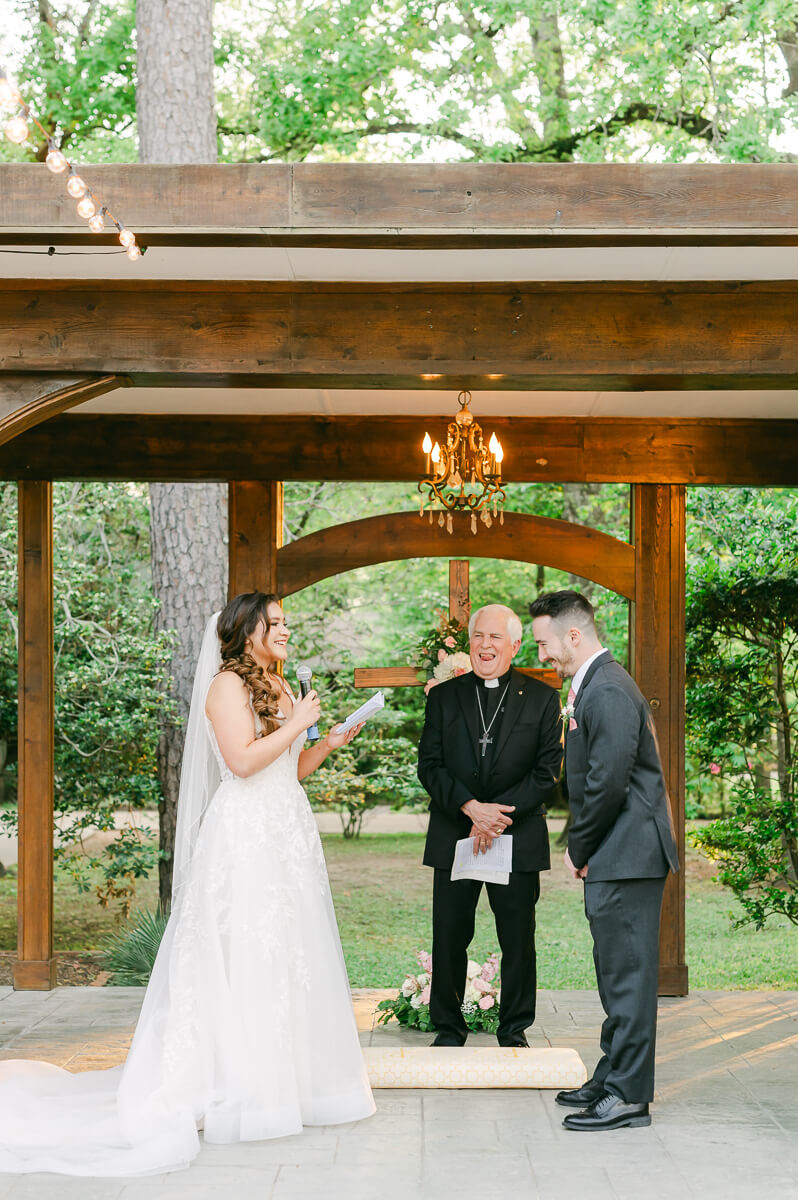 couple reading vows during garden ceremony