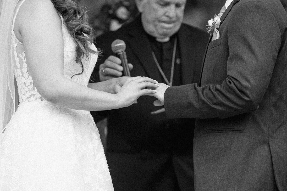 close up of hands during ceremony in black and white