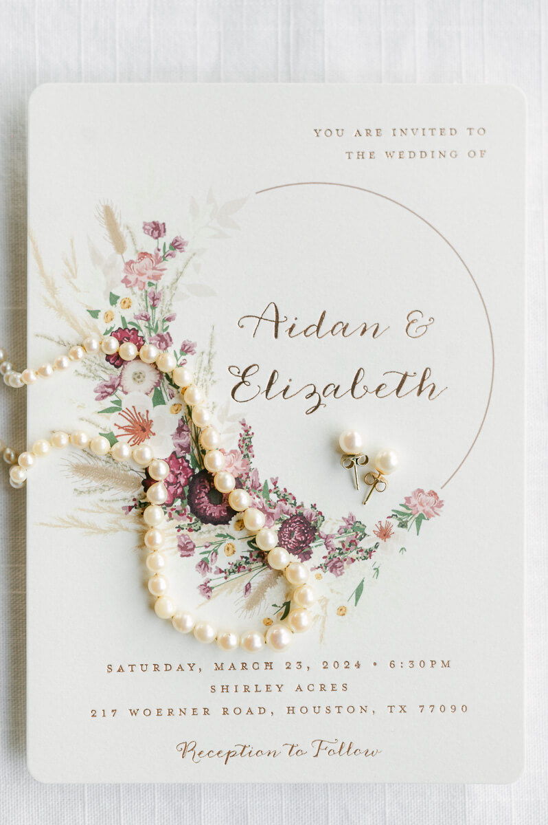wedding invitation with bride's necklace