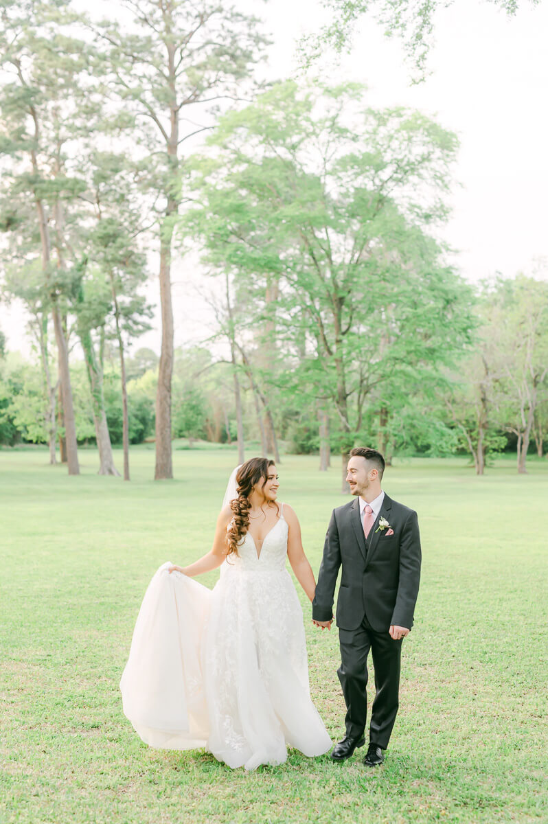 couple walking at their Houston garden wedding
