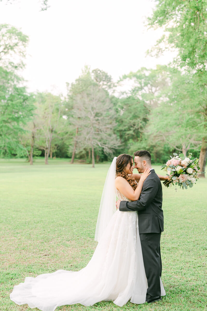 couple cuddling at their Houston garden wedding