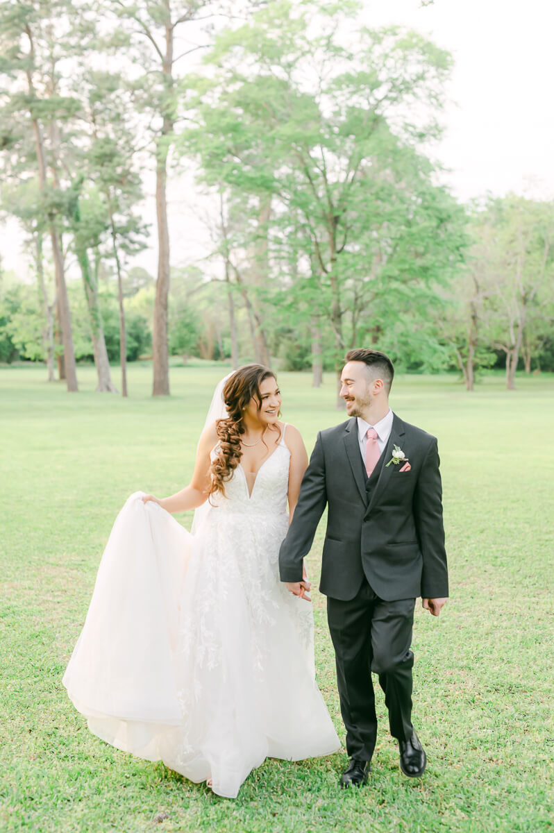 couple walking at their Houston garden wedding