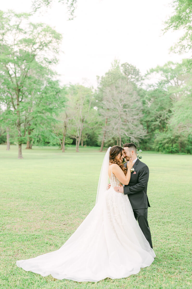 couple cuddling at their Houston garden wedding