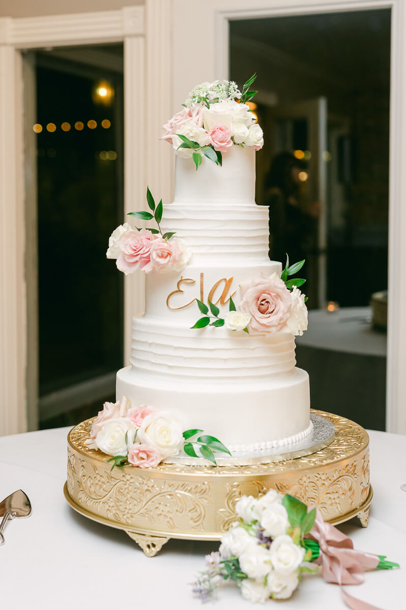 wedding cake with pink flowers an greenery