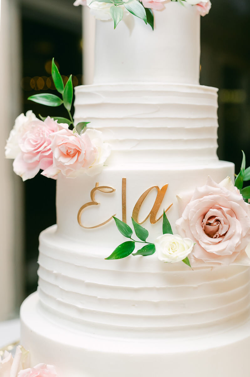 wedding cake with pink flowers an greenery
