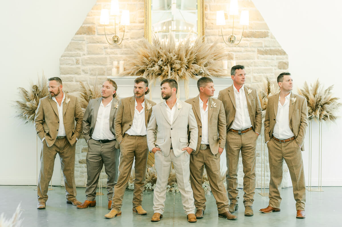 groomsmen wearing khaki in front of fireplace