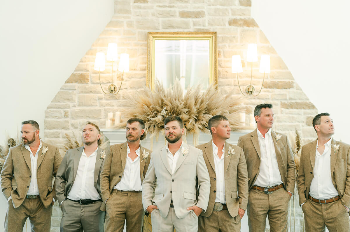 groomsmen wearing khaki in front of fireplace