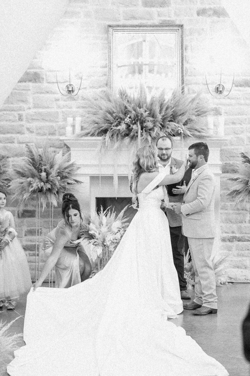 bride wiping tears from groom's face