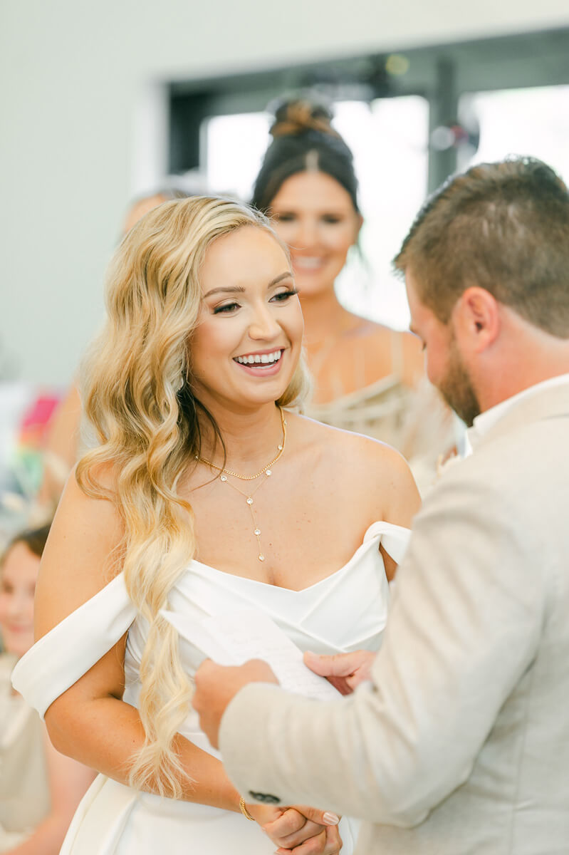 bride laughing during wedding ceremony