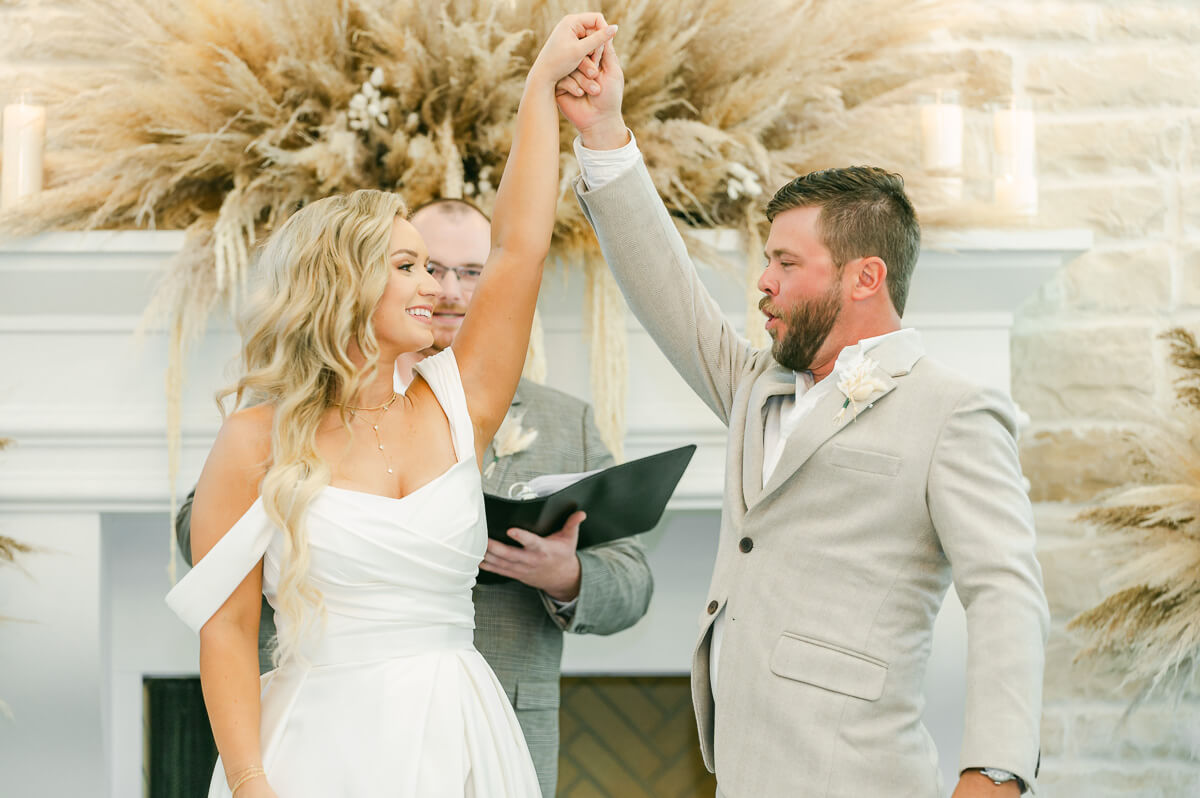 bride and groom cheering after ceremony