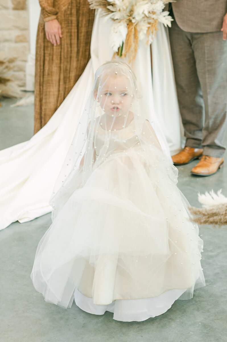 flower girl in dress being silly