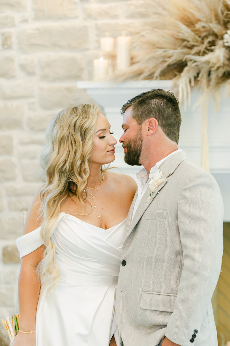 bride and groom in front of fireplace at Magnolia Grove