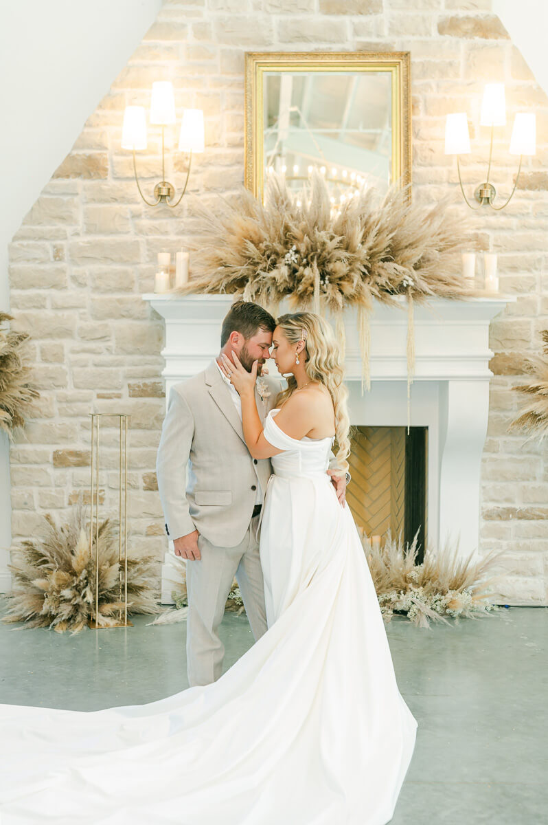 bride and groom in front of fireplace at Magnolia Grove