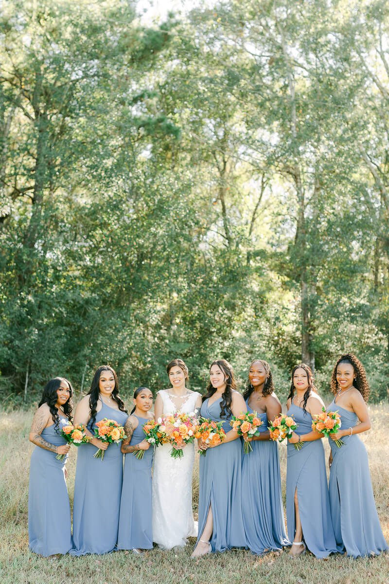 bridesmaids in blue dresses at magnolia meadows wedding venue