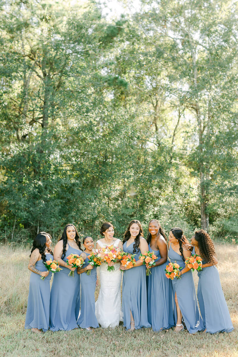 bridesmaids in blue dresses at magnolia meadows wedding venue