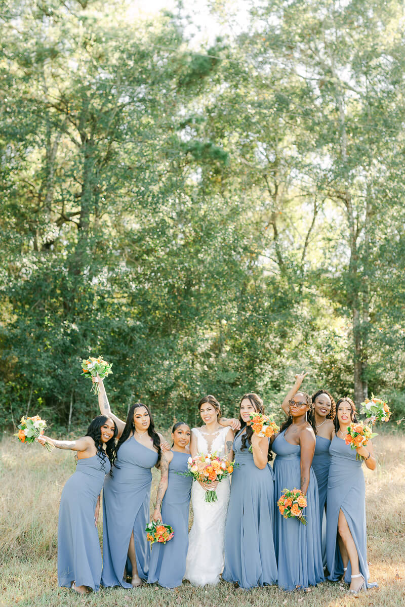 bridesmaids in blue dresses at magnolia meadows wedding venue