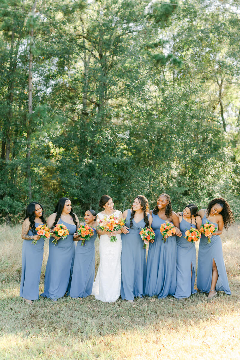 bridesmaids walking outside magnolia meadows wedding venue