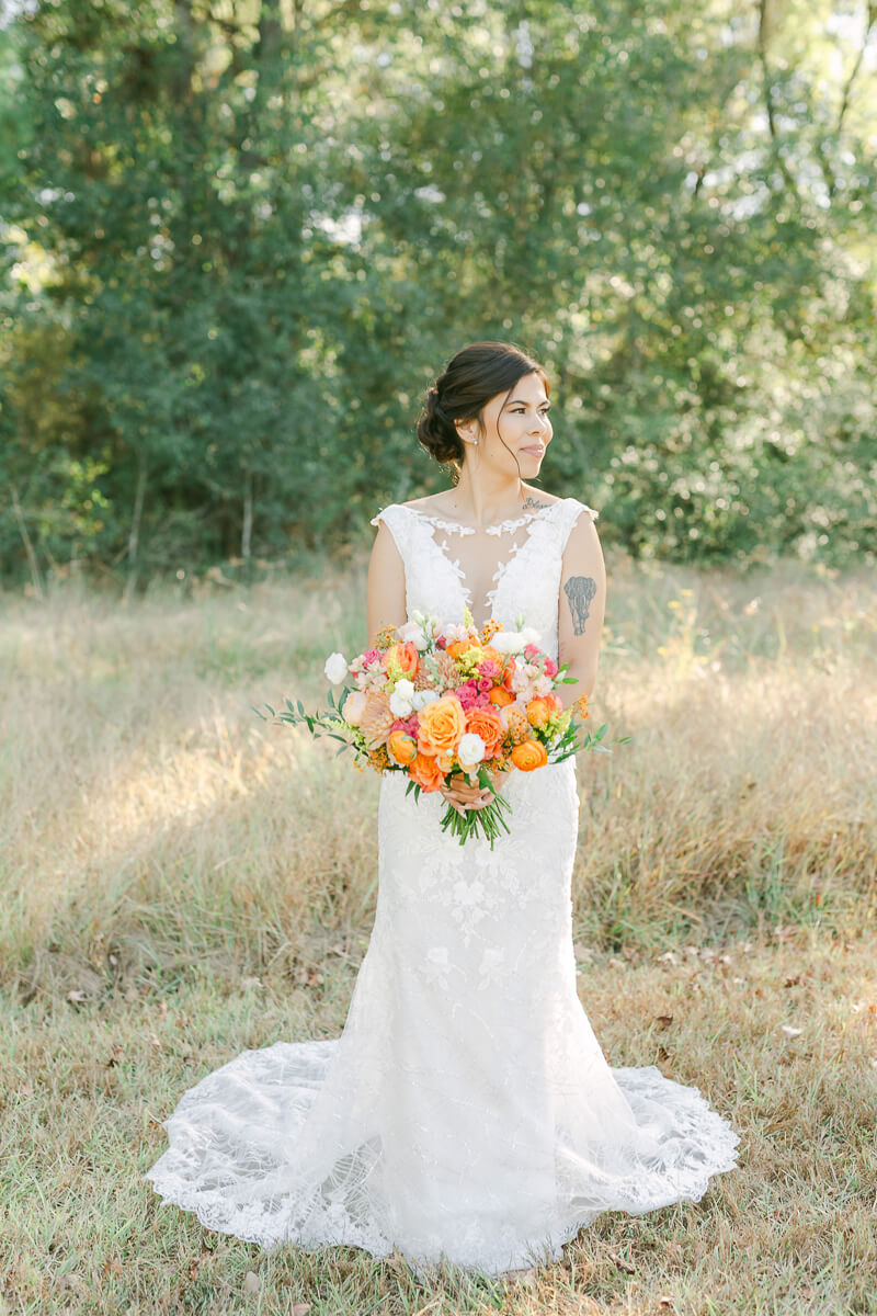 bride in field at magnolia meadows 